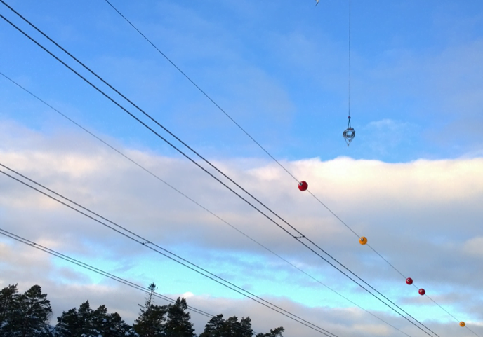 helicopter installing a air warming marker in a poweline